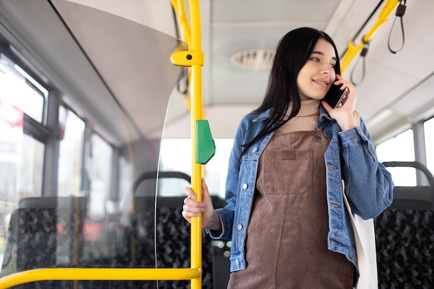 Mulher grávida em tiro médio falando ao telefone