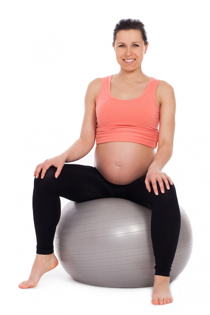 Mulher grávida, sentando bola