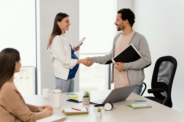 Mulher grávida tendo uma reunião com seu colega de trabalho