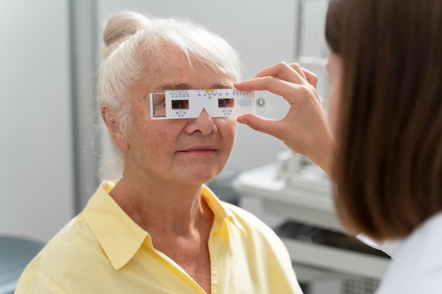 Mulher idosa fazendo exame de vista em uma clínica de oftalmologia
