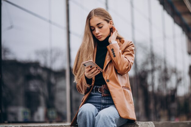 Mulher jovem com casaco andando pela cidade