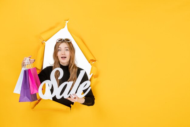Mulher jovem com pequenos pacotes depois das compras
