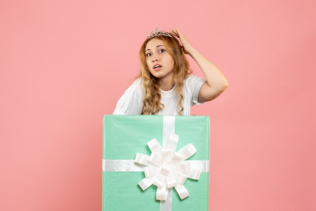 Mulher jovem de frente dentro de uma caixa de presente azul