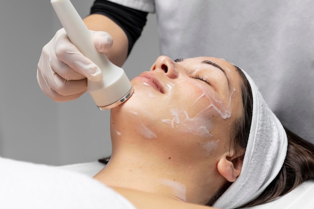 Mulher jovem fazendo tratamento facial