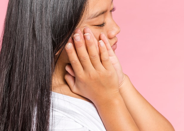 Mulher lateralmente segurando as mãos para dormir