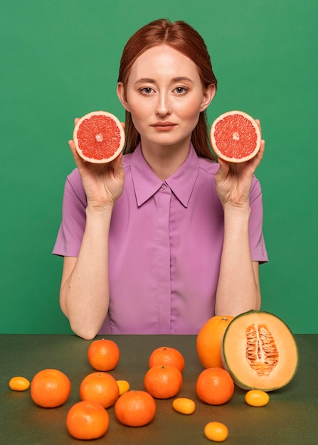 Foto grátis mulher linda ruiva posando com frutas