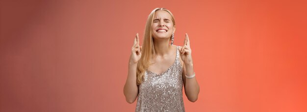 Mulher loira preocupada faz esforço deus ouve orações intensas olhos fechados dentes cerrados cabeça erguida