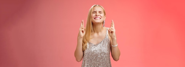 Mulher loira preocupada faz esforço deus ouve orações intensas olhos fechados dentes cerrados cabeça erguida