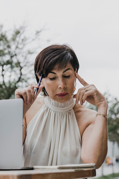 Mulher mais idosa olhando no notebook tiro médio