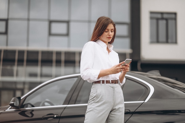 Mulher negócio, ficar, por, a, car, e, usando, telefone