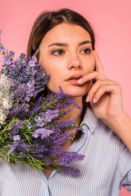 Mulher pensativa com buquê de flores