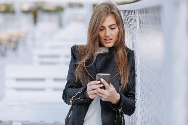 Mulher que olha seu Smartphone