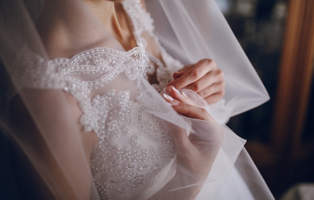 Mulher que toca em seu vestido de casamento