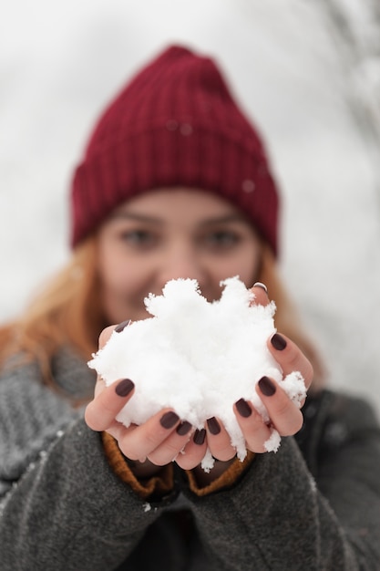 Foto grátis mulher segurando neve nas mãos dela