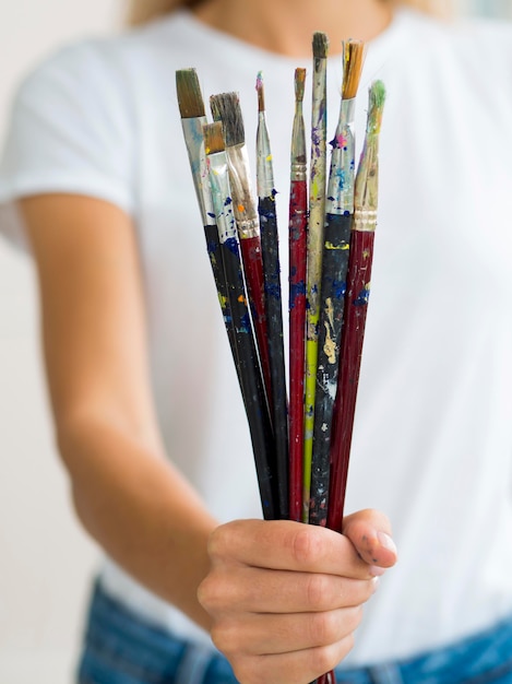 Mulher segurando tinta escovada na mão