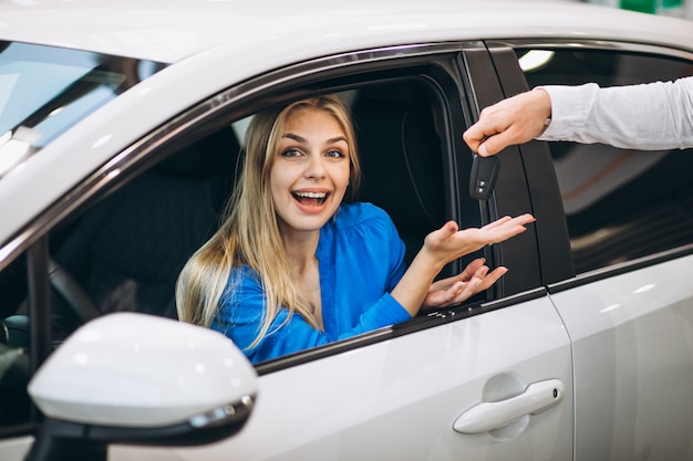 Foto grátis mulher, sentando, carro, recebendo, teclas, carro, showroom