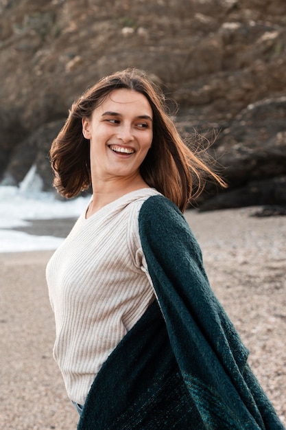 Mulher sorridente curtindo o tempo na praia