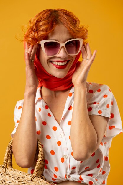 Mulher sorridente de tiro médio com óculos de sol