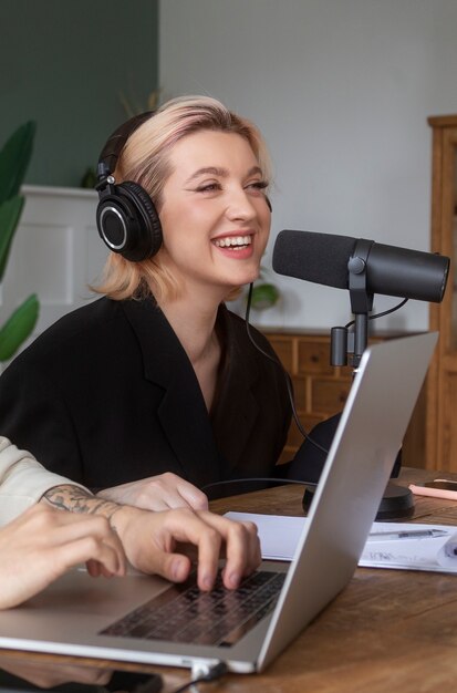 Mulher sorridente de tiro médio gravando podcast