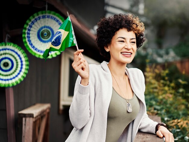 Mulher sorridente de tiro médio segurando a bandeira