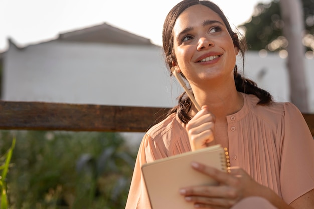 Mulher sorridente escrevendo plano médio