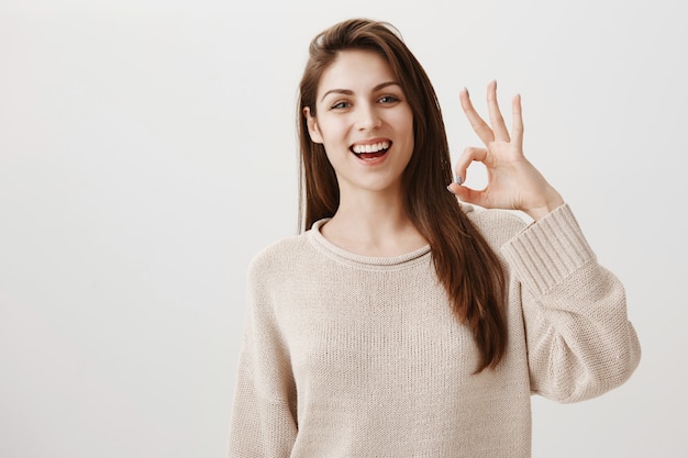 Mulher sorridente feliz mostrando gesto de ok satisfeito, aprovar ou recomendar o produto
