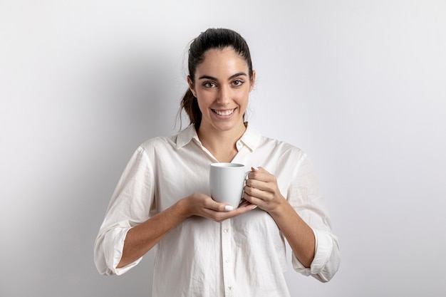 Mulher sorridente posando com caneca