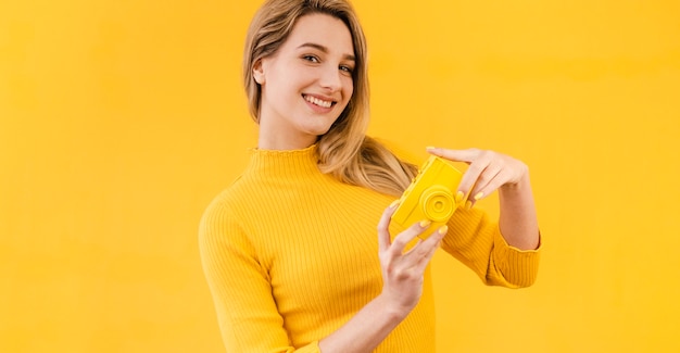 Mulher sorridente segurando a câmera