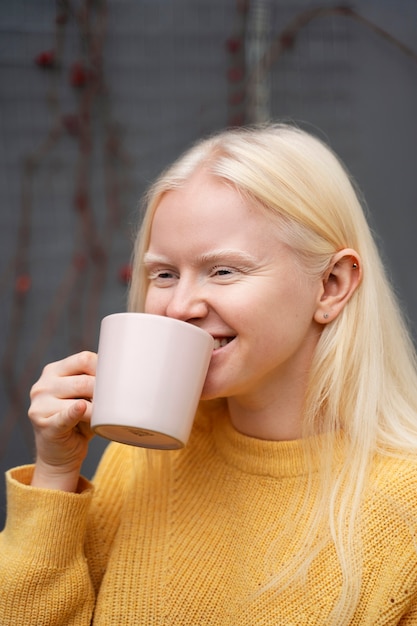 Mulher sorridente segurando a xícara de café plano médio