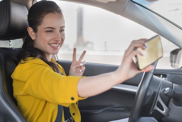 Mulher tomando uma selfie no carro