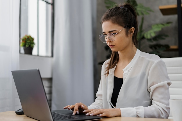 Mulher trabalhando em um laptop em casa