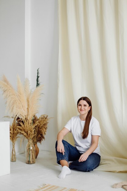 Mulher vestindo camiseta branca em branco em pé no fundo