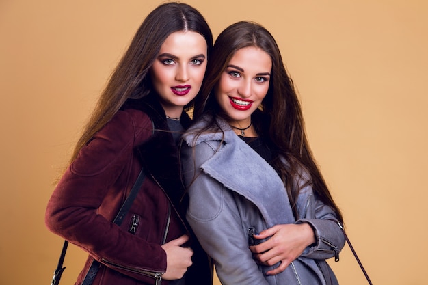 Mulheres bonitas glamourosas posando e vestindo jaquetas de inverno casuais