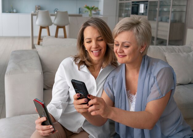 Mulheres de tiro médio lendo mensagens de celular