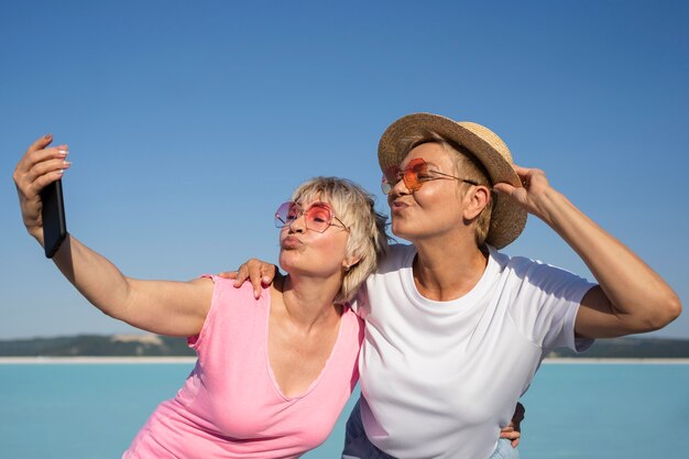 Mulheres em tiro médio tirando selfie