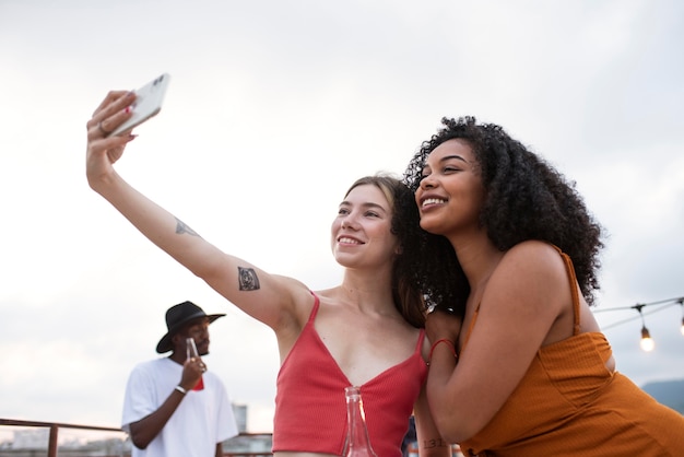 Mulheres em tiro médio tirando selfie