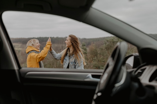 Mulheres felizes cumprimentando tiro médio