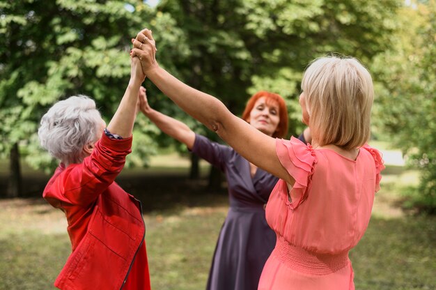 Mulheres maduras tocando juntos no parque