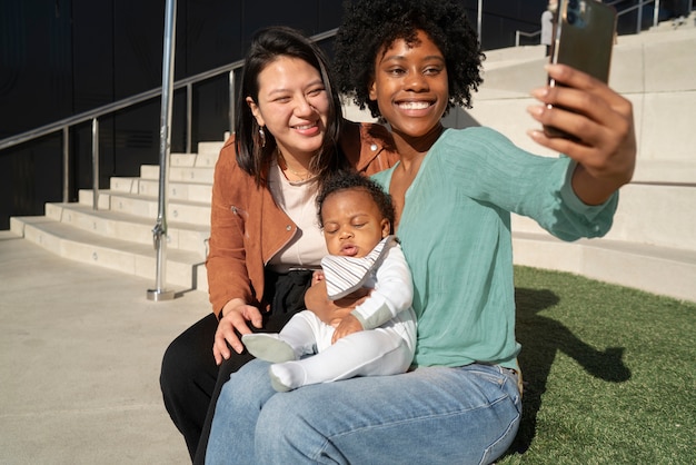 Mulheres sorridentes tomando selfie tiro médio