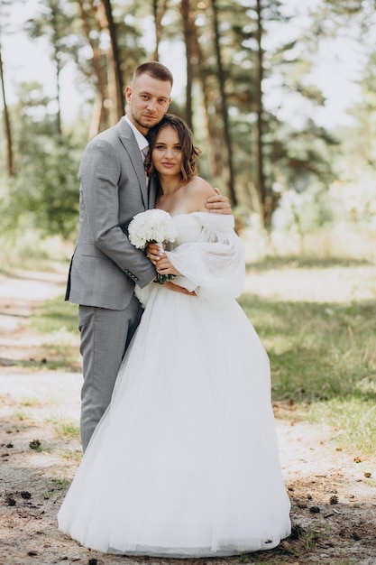 Noivo e noiva no dia do casamento na floresta