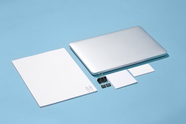 Foto grátis o laptop, canetas, telefone, nota com tela em branco na mesa