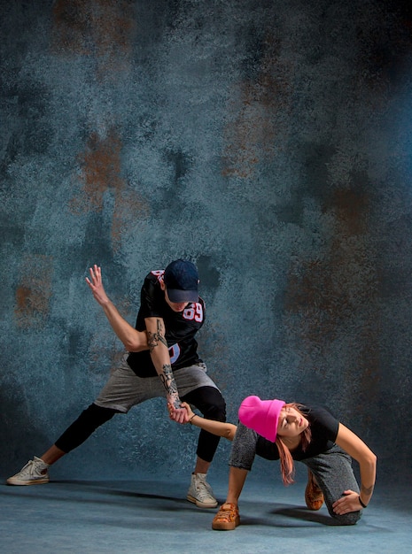 Os dois jovem e menino dançando hip hop no azul