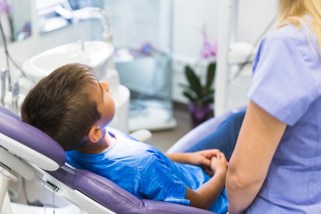 Paciente criança, inclinar-se, cadeira dental, em, clínica