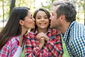 Foto grátis pai beijando sua filha no jardim