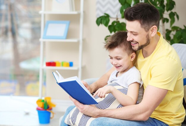 Pai e filho lendo livro interessante em casa