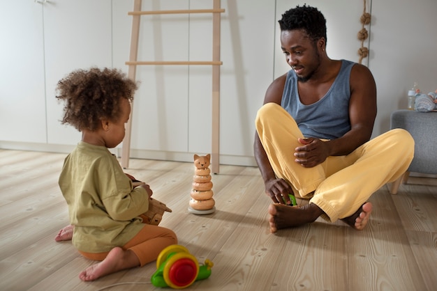 Foto grátis pai passando tempo com seu bebê negro