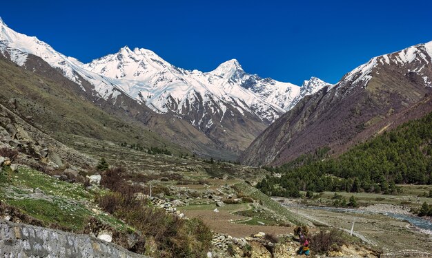 Paisagem das montanhas cobertas de neve do Himalaia perto da vila de Chitkul em Kinnaur, Índia