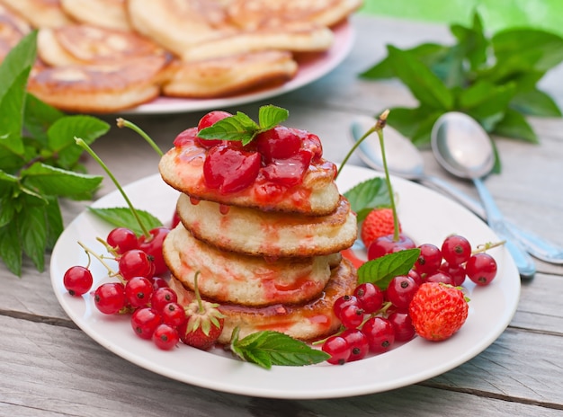 Panquecas com frutas em uma mesa de madeira em um jardim de verão