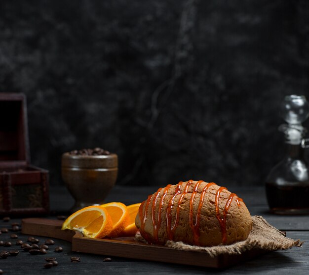 Pão doce com calda de cereja e frutas fatiadas de laranja