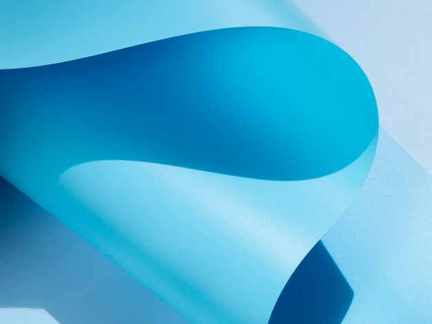 Papel monocromático curvado abstrato azul